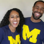 Husband and wife laughing together wearing Michigan shirts for how to have a happy marriage