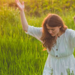 How to Grow Spiritually woman with arms raised in prayer and surrender