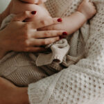 Close up of mother holding her baby. Encouraging bible verses for mothers.