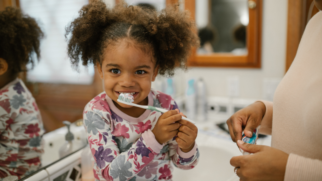 Black toddler little girl brushing her teeth as her toddler bedtime routine.